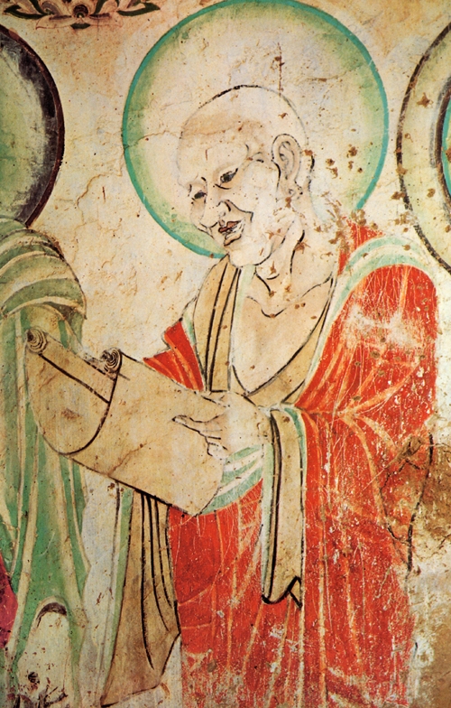 Peinture murale représentant un moine lisant un rouleau.